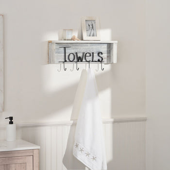 A white wooden shelf with black metal lettering that spells 