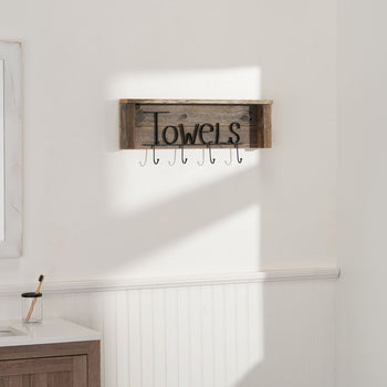 A rustic wooden towel rack with the word 