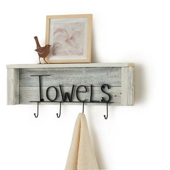 A rustic wooden shelf with a whitewashed plank backing and black metal lettering that spells 