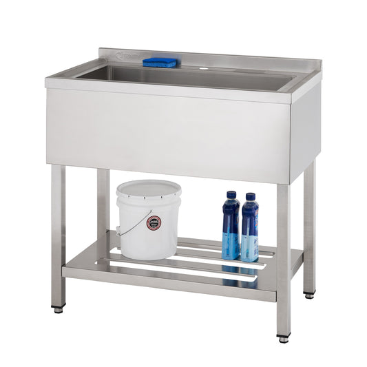 A stainless steel utility sink with a single basin sits atop a metal frame with a shelf. A white bucket and two blue bottles are placed on the shelf beneath the sink.