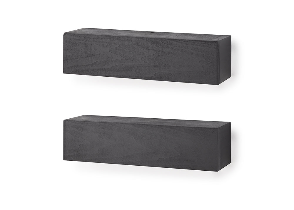 Two rectangular floating wall shelves made of black wood with a visible natural grain pattern are displayed against a white background. The shelves are arranged vertically, one above the other, showing a thick box-style design and clean edges.