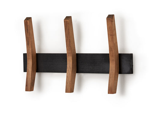 A modern wall-mounted coat rack featuring three angled wooden hooks attached to a black horizontal base. The hooks have a natural wood finish and a slightly curved design, adding a sculptural touch to the piece.