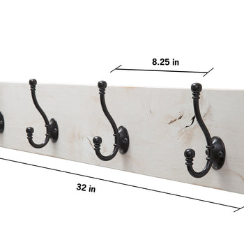A horizontal, whitewashed wooden plank is mounted with four ornate, dark metal double hooks evenly spaced across its length. The image includes dimension labels indicating the plank is 32 inches long, 3 inches deep, and 5.5 inches high, with each hook spaced approximately 8.25 inches apart.