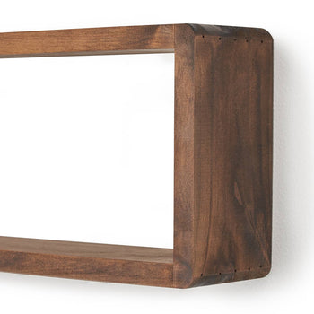 A close-up shot of a stackable floating box shelf mounted on a white wall, casting a subtle shadow. The wooden shelf has a rich brown tone and a rectangular opening, showcasing its minimalist and functional design.