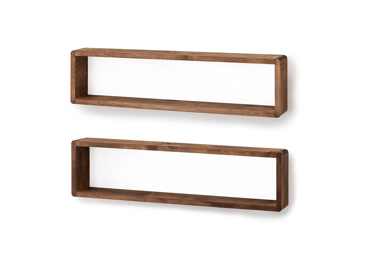 Two long, rectangular wooden box shelves are mounted on a plain white wall, one above the other. The shelves have a warm, medium-brown wood tone and rounded edges, creating a minimalist and functional design.