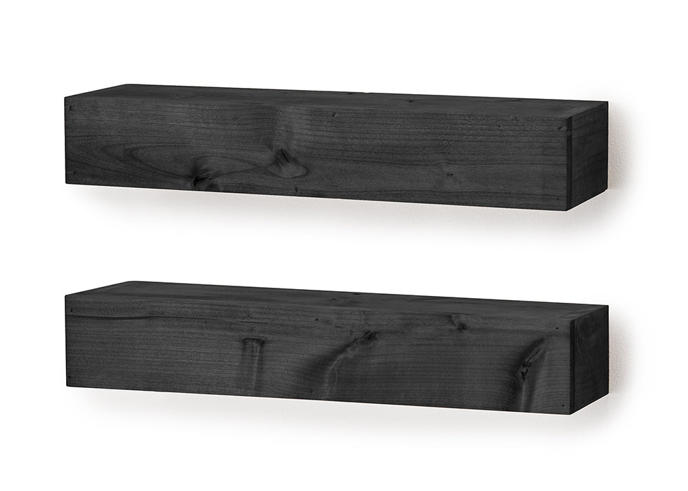 Two thick, rectangular floating shelves featuring a dark charcoal wood grain finish are mounted against a white wall. The shelves are positioned horizontally, one above the other, showcasing natural knots and textures in the wood.