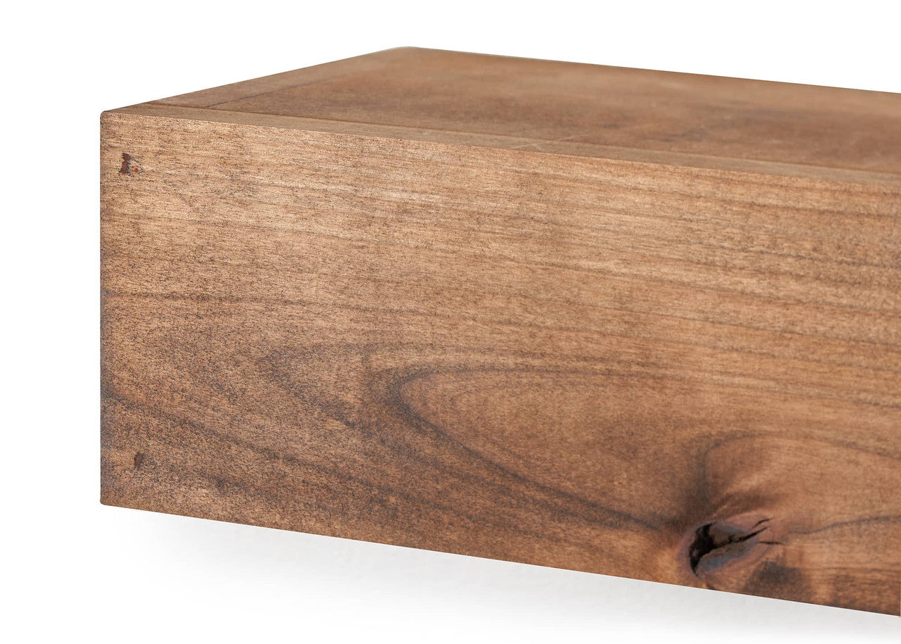 Close-up shot of a walnut floating shelf, showcasing its rich wood grain and the joinery detail on the corner. The shelf is rectangular with a smooth finish, suggesting a modern or minimalist design.
