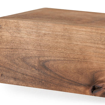Close-up shot of a walnut floating shelf, showcasing its rich wood grain and the joinery detail on the corner. The shelf is rectangular with a smooth finish, suggesting a modern or minimalist design.