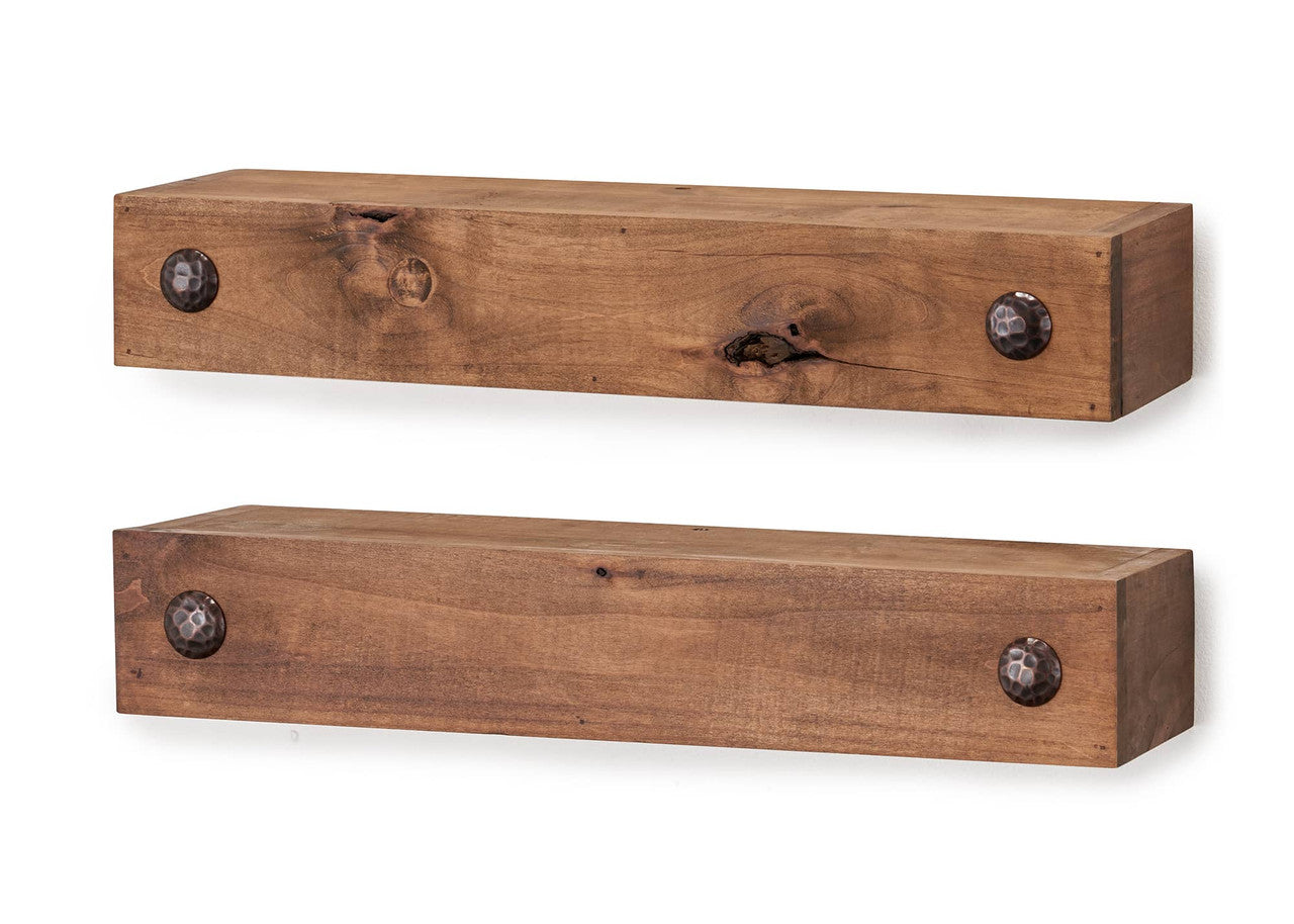 A set of two rustic wooden floating shelves with a natural wood grain finish, mounted on a white wall. Each shelf has two dark, hammered metal accents on the front face, adding a decorative touch.