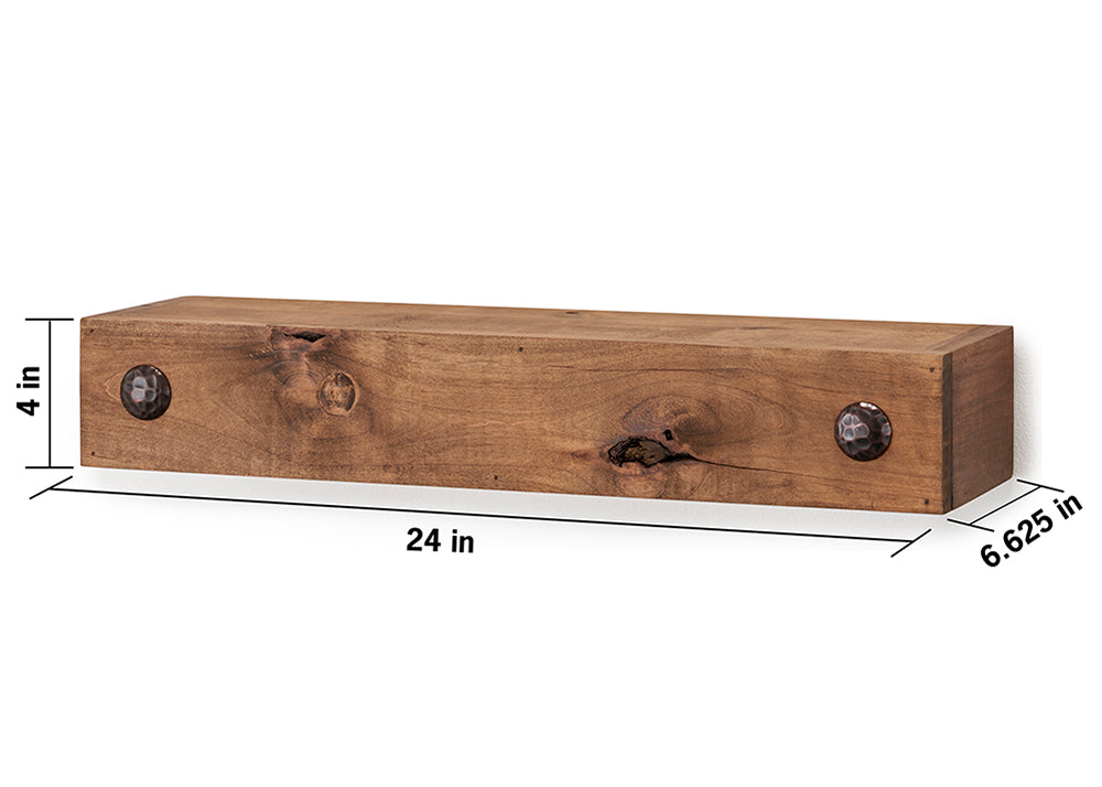 A rectangular wooden floating shelf is shown against a white background. The shelf is 24 inches long, 4 inches high, and 6.625 inches deep, and features two decorative dark metal clavos on the front.