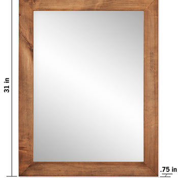 A rectangular wall mirror features a rustic wooden frame with visible grain. The mirror measures 31 inches in height and 24 inches in width, with the frame having a thickness of 0.75 inches.
