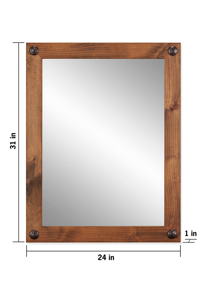 A rectangular farmhouse-style vanity mirror with a rustic wooden frame is shown against a white background. The mirror measures 24 inches wide and 31 inches tall, and the frame is 1 inch thick, featuring decorative clavos or nail heads at each corner.