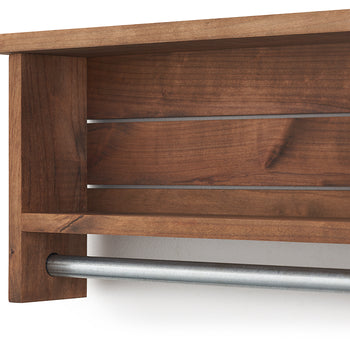 A close-up shows a brown wooden towel bar with two shelves attached to a white wall. A cylindrical metal towel rod extends horizontally along the bottom.