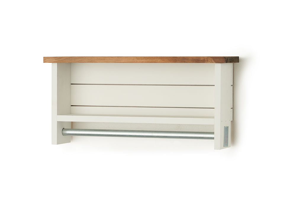A white wooden towel bar with two shelves and a natural wood top is mounted on a white wall. The towel bar is a silver metal rod extending horizontally beneath the lower shelf.