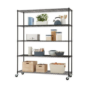 A tall, black wire shelving unit with five shelves is filled with kitchen and storage items. The shelves hold a variety of objects including books, a potted plant, kitchen tools, canisters, a toaster, containers with utensils, mixing bowls, wooden crates, and a fabric basket filled with onions.
