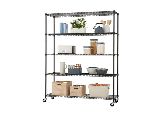 A tall, black wire shelving unit with five shelves is filled with kitchen and storage items. The shelves hold a variety of objects including books, a potted plant, kitchen tools, canisters, a toaster, containers with utensils, mixing bowls, wooden crates, and a fabric basket filled with onions.