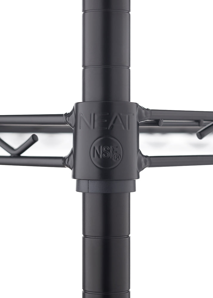 A close-up photograph shows a black wire shelving unit's connector, where a horizontal shelf wire meets a vertical pole. The connector is black plastic or metal and features the brand name "NEAT" above an "NSF" certification logo.