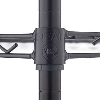 A close-up photograph focuses on a black metal wire shelving unit where a shelf connects to a vertical pole. The shelf collar is branded with 