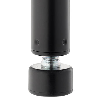 A close-up photograph shows the bottom of a black, cylindrical metal post resting on an adjustable leveling foot. The foot consists of a threaded, galvanized metal bolt screwed into the post's base and a wide, black rubber or plastic pad that makes contact with the floor.