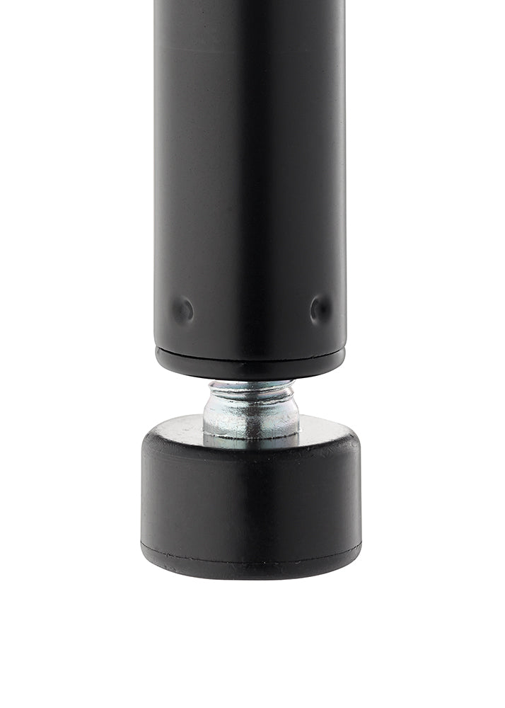 A close-up photograph shows the bottom of a black, cylindrical metal post resting on an adjustable leveling foot. The foot consists of a threaded, galvanized metal bolt screwed into the post's base and a wide, black rubber or plastic pad that makes contact with the floor.