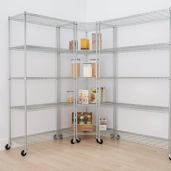 A two-unit chrome wire shelving system is assembled in the corner of a room, creating an L-shape with five shelves each. The shelves are on casters and hold various pantry items like cereal, flour, snacks, and bottles.