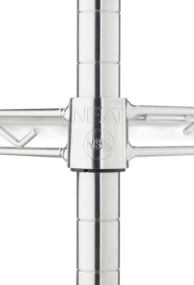 A close-up photograph focuses on a chrome wire shelving unit's central joint, where a shelf meets a vertical post. The joint collar is embossed with the brand name "NEAT" and the NSF certification mark.