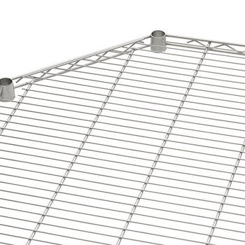 A close-up view of a chrome wire shelf with a pentagonal or corner shape. The shelf features two metal sleeves or collars at two adjacent corner points, which are typically used to secure it to shelving posts.