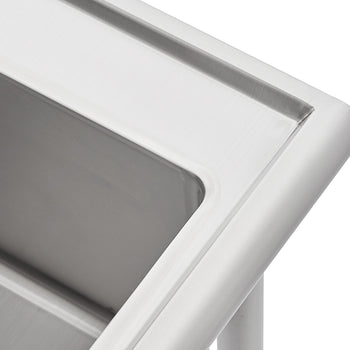 A close-up photograph shows the corner of a stainless steel sink or basin. The image highlights the smooth, brushed finish, rounded edges, and the top lip of the fixture.