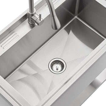 A top-down view of a modern stainless steel kitchen sink with a single large basin. The sink features a faucet with a pull-down sprayer and an integrated drainer area to the left.