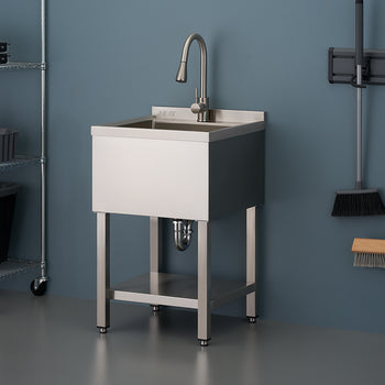 A close-up photograph features a stainless steel utility sink on a stand with a lower shelf, complete with a modern gooseneck faucet. The sink is set against a blue wall in what appears to be a garage or laundry room, with wire shelving on the left and cleaning tools hanging on the right.