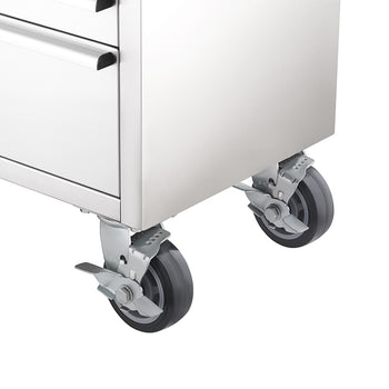 A close-up view highlights the bottom corner of a stainless steel tool workbench, showing heavy-duty swivel casters equipped with foot-operated locking levers.