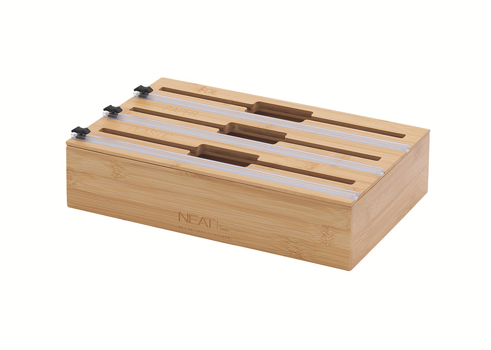 A three-tier bamboo organizer is shown with individual slots engraved for foil, paper, and plastic wrap. Each section features a clear sliding track with a black cutter for easy and precise dispensing.