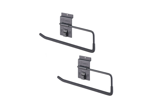 A set of two identical, dark gray utility hooks designed for slatwall or pegboard systems is shown. Each hook has a rectangular mounting plate with the "TRINITY" logo and a long, U-shaped arm with a non-slip coating, likely used for hanging tools, cords, or towels.