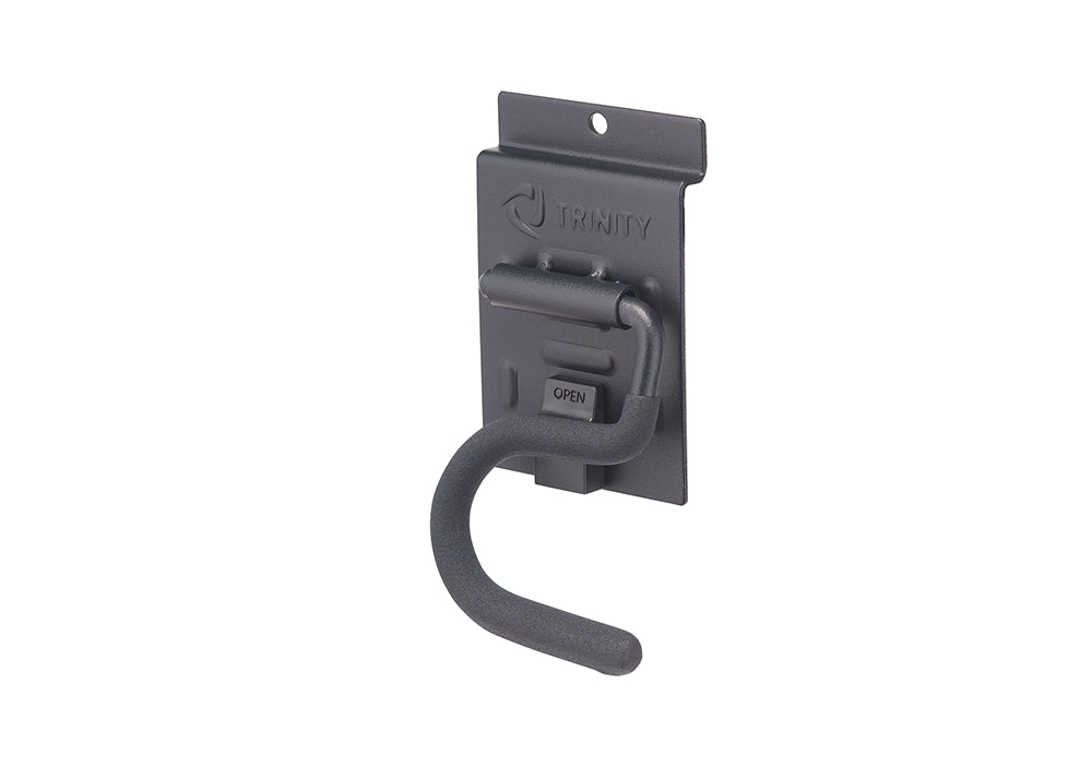 A dark gray metal garage storage hook features a curved, textured arm designed for hanging tools or equipment. It is mounted on a matching rectangular backplate displaying the embossed "TRINITY" logo at the top and a small latch labeled "OPEN."