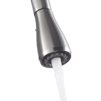 A close-up of a brushed stainless steel kitchen faucet with a pull-down spray head. Water is flowing out of the sprayer in a steady, aerated stream.