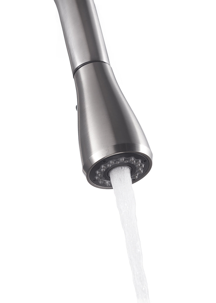 A close-up of a brushed stainless steel kitchen faucet with a pull-down spray head. Water is flowing out of the sprayer in a steady, aerated stream.