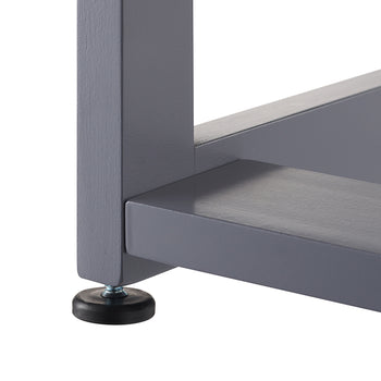 A close-up shot focuses on the bottom corner of a gray furniture frame, showing the intersection of three square beams. A small, black adjustable leveling foot is screwed into the base of the vertical leg to provide stability.
