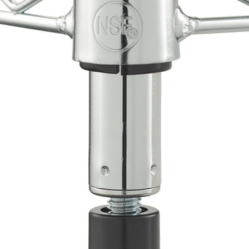 A close-up photograph displays the adjustable leveler foot on a chrome wire shelving unit, showing a black foot and threaded screw. Above the foot, the post connection features embossed text with "TRINITY BASICS" and the NSF certification mark, against a plain background.