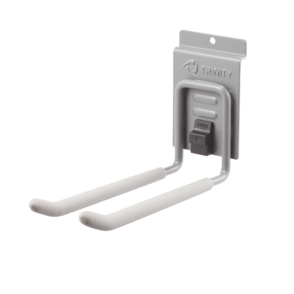 A gray metal wall-mounted storage hook with padded arms and a locking mechanism labeled "OPEN" from the brand TRINITY. The hook is designed for holding items such as ladders, tools, or sports equipment.