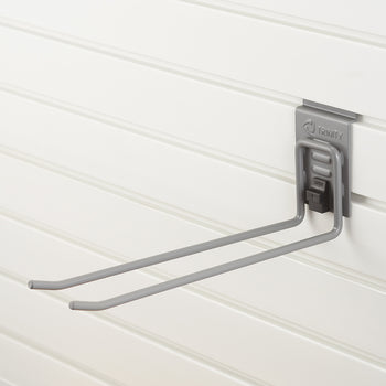 A gray metal double-prong hook is mounted on a white slatwall panel. The hook is branded 