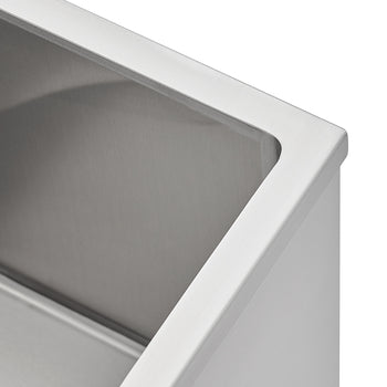 A close-up shot of a modern stainless steel kitchen sink featuring a brushed metal finish and tight-radius corners. The image highlights the clean lines of the sink's rim and the smooth, reflective interior surface.