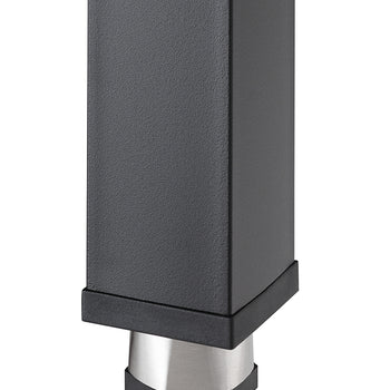A close-up shot of the lower portion of a rectangular, dark gray or black furniture leg with a textured, matte finish. The bottom of the leg is fitted with a silver-colored, hexagonal foot with a black rubberized base.