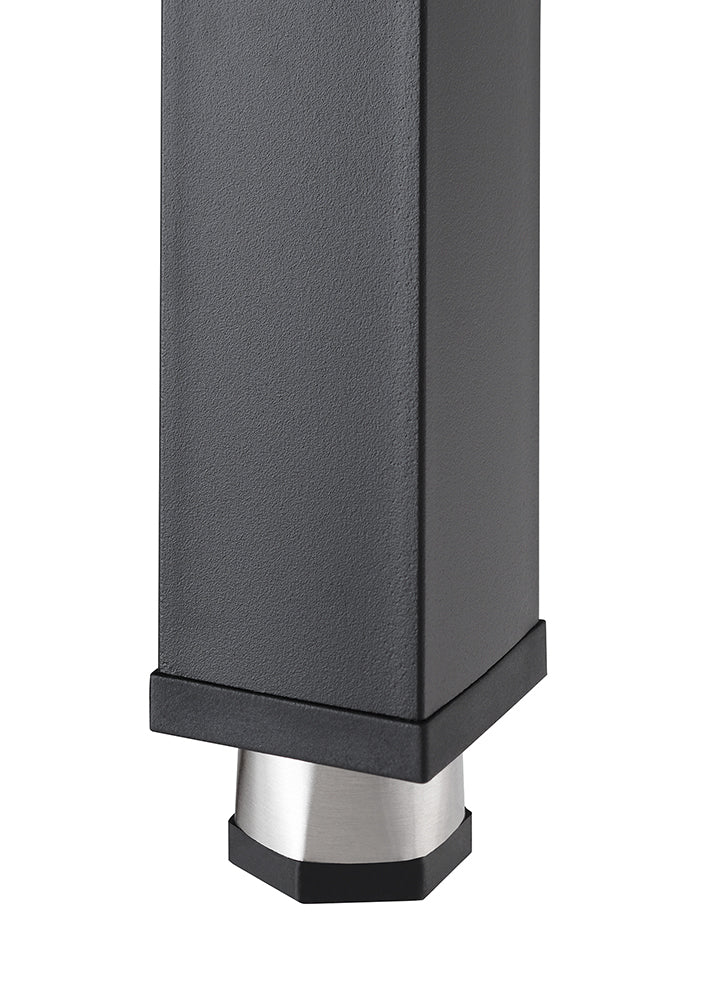 A close-up shot of the lower portion of a rectangular, dark gray or black furniture leg with a textured, matte finish. The bottom of the leg is fitted with a silver-colored, hexagonal foot with a black rubberized base.