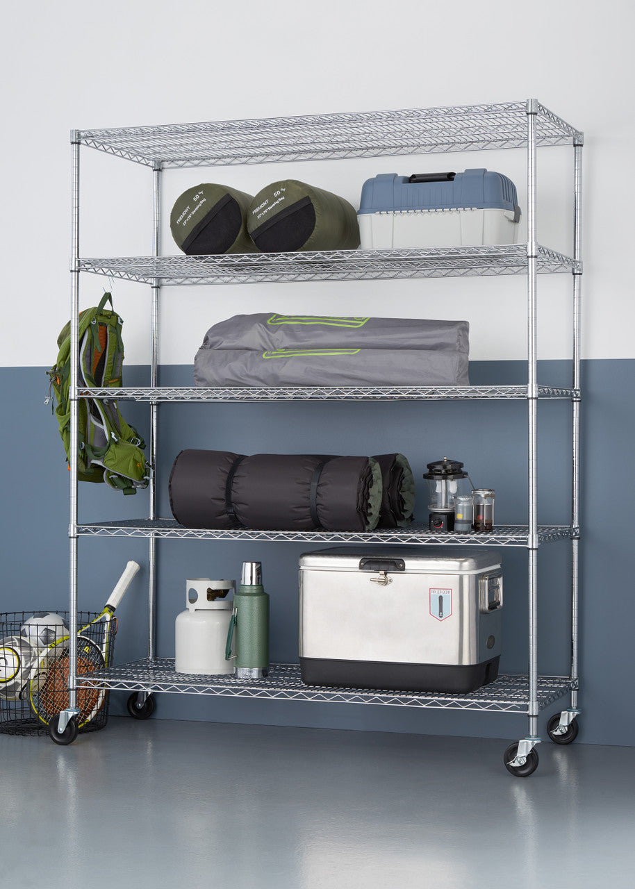 A five-tier wire shelving unit on wheels holds various camping and sports equipment against a two-toned wall. The shelves contain items like sleeping bags, a tent, a cooler, and sports balls, showcasing organized storage.