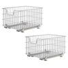 Two chrome wire storage baskets with slides are stacked vertically against a white background. The baskets are rectangular, made of a grid of thin metal wires, and feature handles on the short sides.