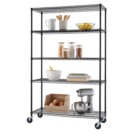 A black, five-tier wire steel garage storage unit stands upright. The shelves hold various items, including kitchen utensils, jars, a bowl, and a stand mixer.