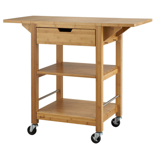 A natural bamboo kitchen cart, is shown with its two drop leaves extended. The cart features a top drawer, two lower shelves, and locking caster wheels, all made from light-colored bamboo.