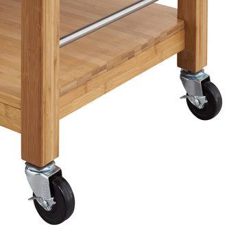 
A close-up view of the bottom portion of a bamboo kitchen cart, focusing on its casters and lower shelf. The cart features sturdy bamboo construction with visible wood grain, a metal bar along the side of the top shelf, and four black swivel casters with silver-toned mounting plates.