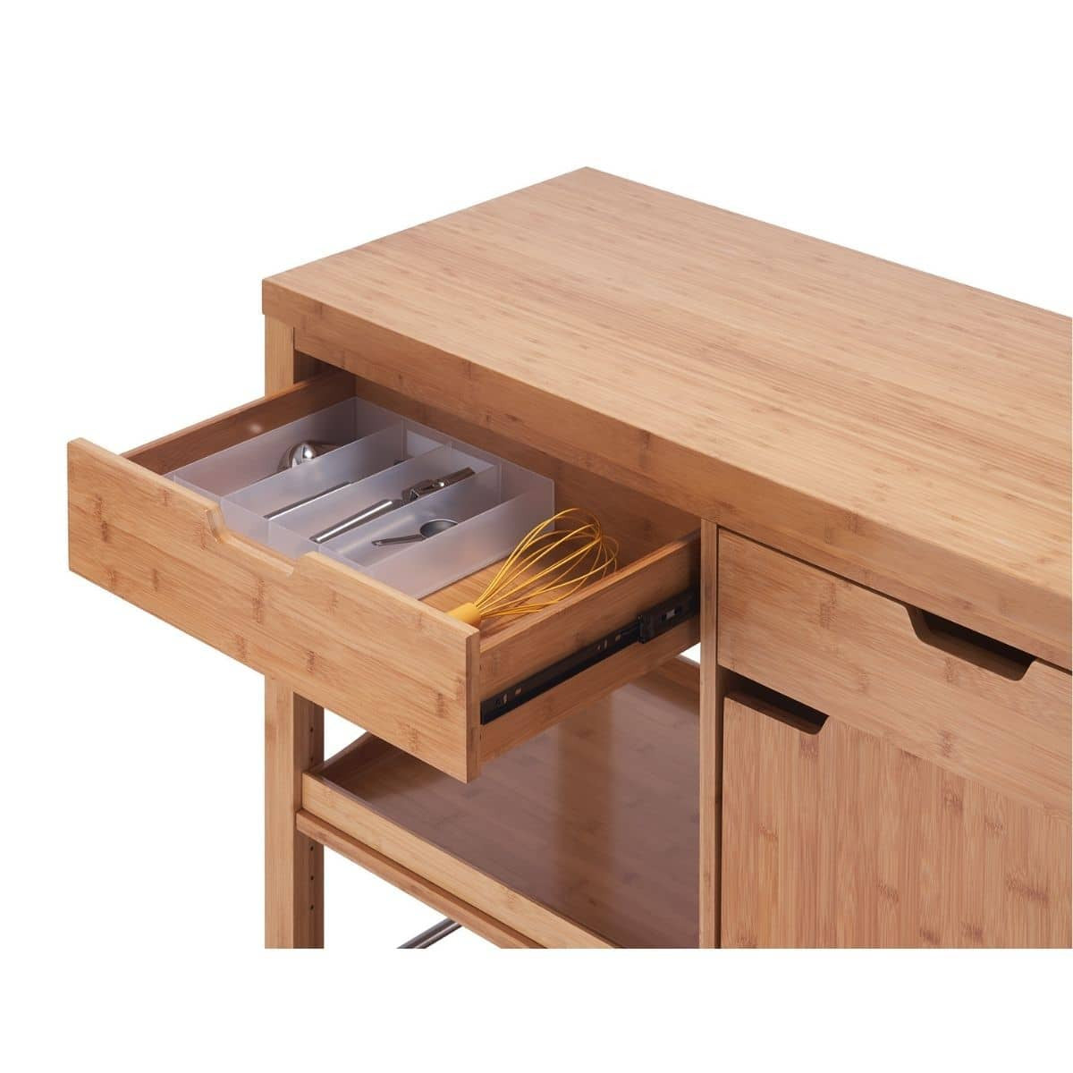 Close up of an extended bamboo kitchen island drawer filled with utensils.