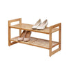 A 2-Tier Stackable Bamboo Shoe Rack. The rack is made of light brown bamboo and has two shelves, each holding a pair of shoes.